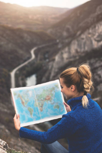 istock Happy travel woman look map 1124547462