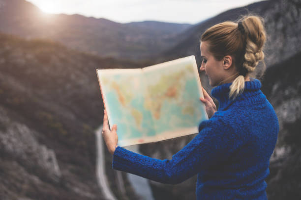 istock Happy travel woman look map 1124547463