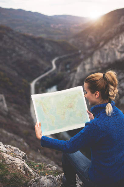 istock Happy travel woman look map 1124547481