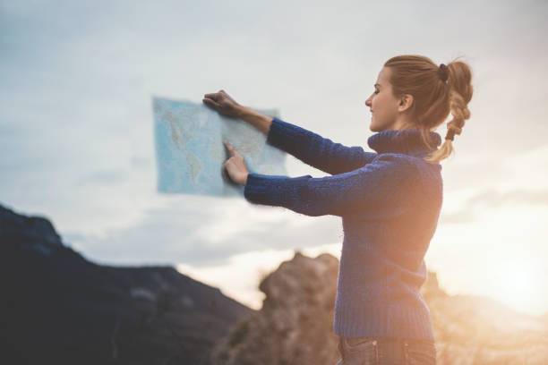 istock Happy travel woman look map 1124547530