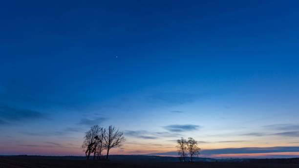 istock Beautiful evening colorful sky over plowed fields 1124547709