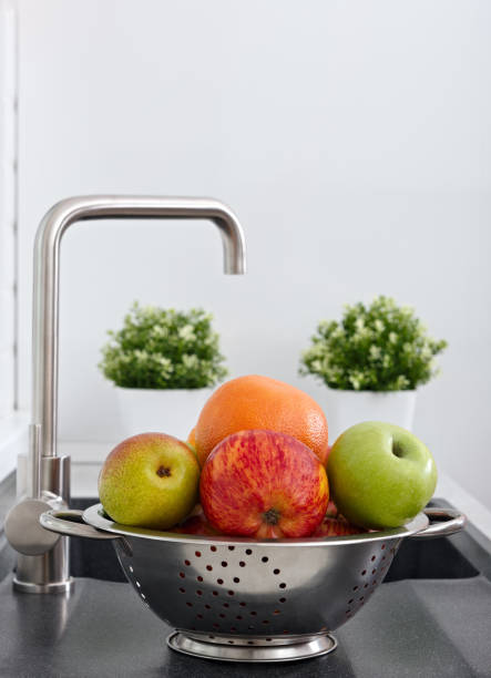 istock Fruit in the cup on the kitchen sink near the water tap. 1124550133