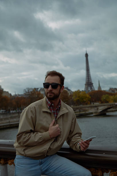 istock Modern man using cellphone in European city. 1124550520