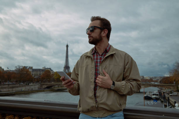 istock Modern man using cellphone in European city. 1124550742