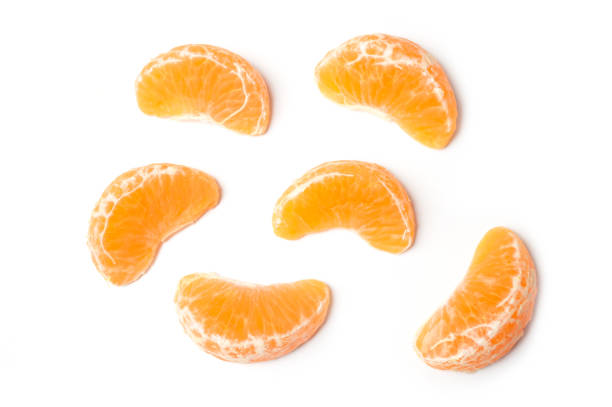 pieces of peeled tangerine on white background