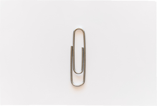 Paper clips, objects used in office or paper work on a white or neutral background.