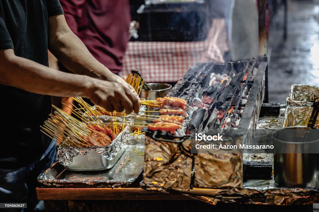 Satay Master A grill and skewer expert at work on Lau Pa Sat hawker center's famous Satay Street. Singapore. Singapore City Stock Photo