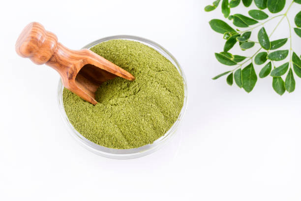 istock Fresh leaves and moringa powder - Moringa oleifera. 1124562739