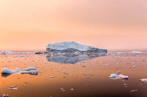 Iceberg on beautiful sea in the sunset