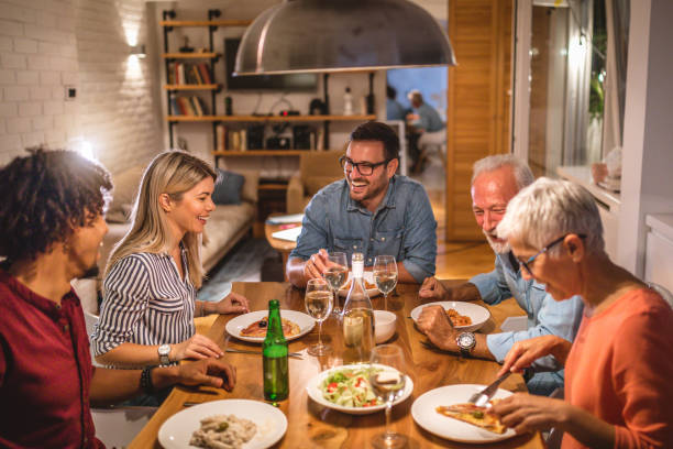istock Group of close firends telling jokes and having fun at a dinner party 1124567220