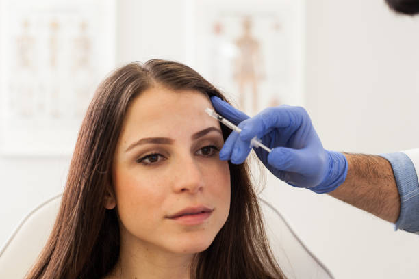 istock Young Woman at a Cosmetologist's Office 1124567492