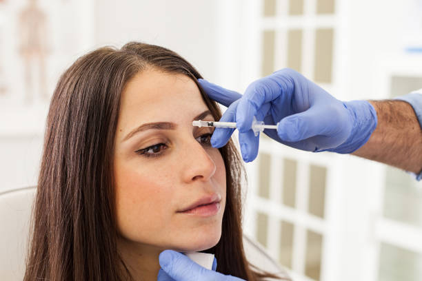 istock Young Woman at a Cosmetologist's Office Getting Botox Injections 1124567498