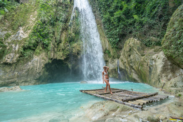 istock Girl contemplating beautiful waterfall 1124570663