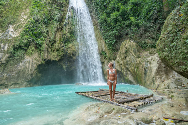 istock Girl contemplating beautiful waterfall 1124570700