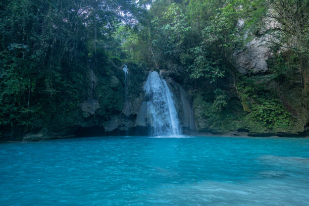 istock Spectacular blue turquoise coloured waterfall in rainforest tropical jungle 1124572173