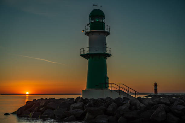 istock The entrance to a harbor with lighthouse at beautiful sunset 1124573071