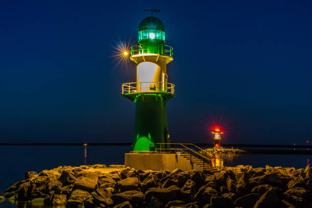 istock two lighthouses at night one green and the other red 1124574283