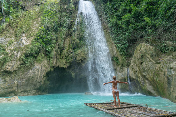 istock Girl embracing beautiful waterfall in the Philippines 1124574291