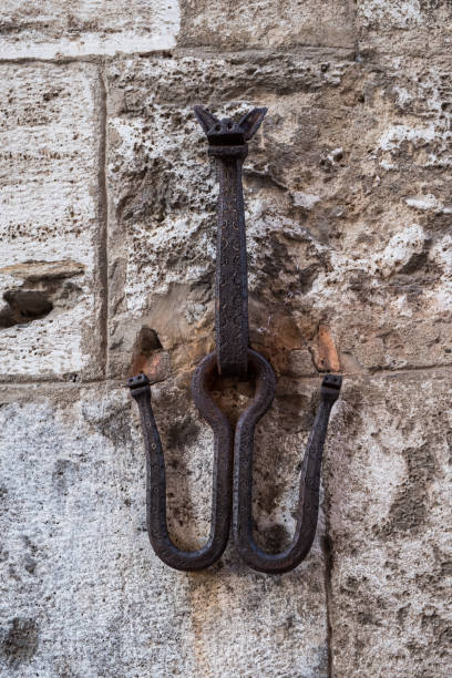 istock Devil shaped hook on a medieval wall in San Gimignano, used to tie horses 1124574561