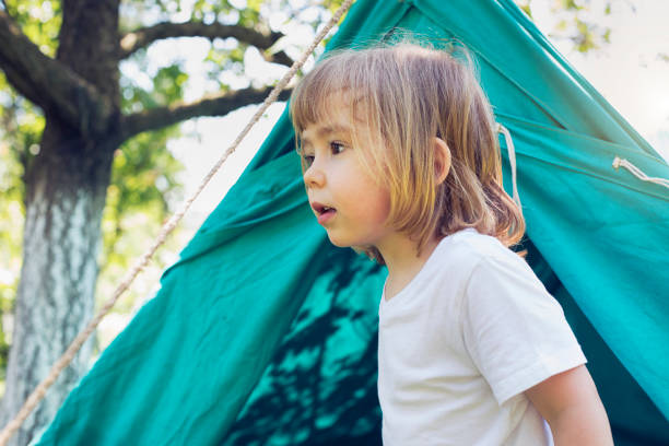 istock Little kid in front of tent 1124578809