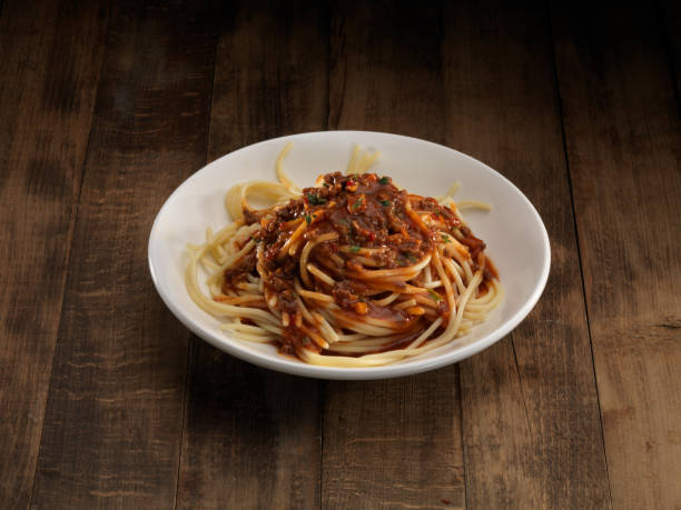 istock Italian pasta with sauce on white plate. 1124578943