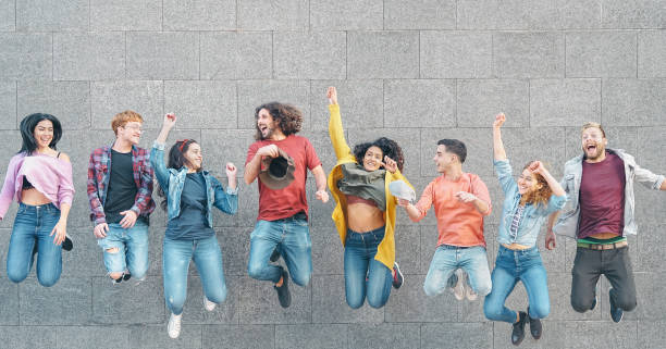 Happy friends jumping together outdoor - Millennial young people having fun celebrating together outside - Concept of friendship, celebration party and youth lifestyle Happy friends jumping together outdoor - Millennial young people having fun celebrating together outside - Concept of friendship, celebration party and youth lifestyle university students australia stock pictures, royalty-free photos & images