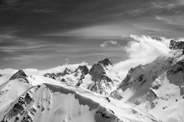 istock Black and white winter mountains with snow cornice 1124593071