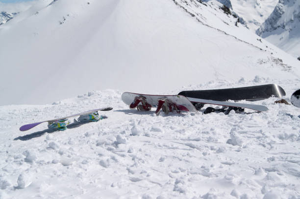 istock Snowboards on snowy slope in high winter mountains 1124593076