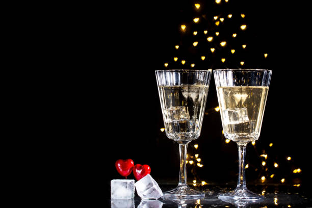 istock Two glasses with a cocktail and two hearts, Valentine's day concept. 1124593869