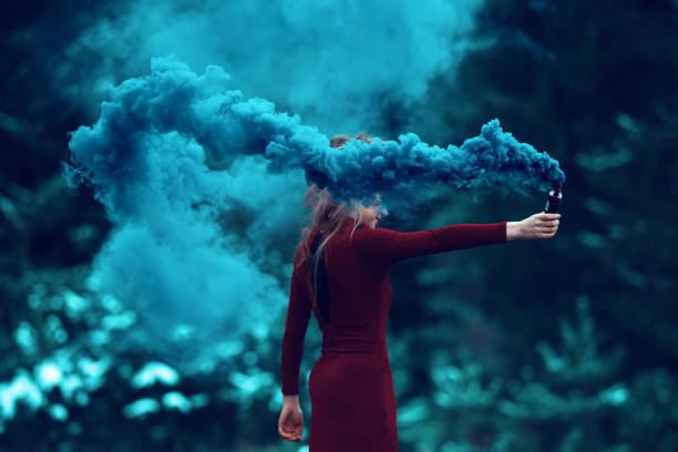 deep smoke from flaming torch side view of woman in the forest holding flaming torch. wizard photos stock pictures, royalty-free photos & images