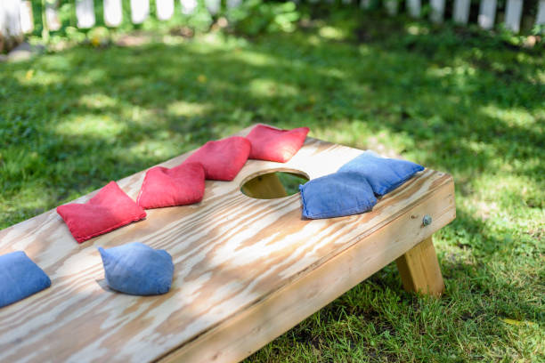 istock Homemade corn hole game board in backyard sunlight 1124598282