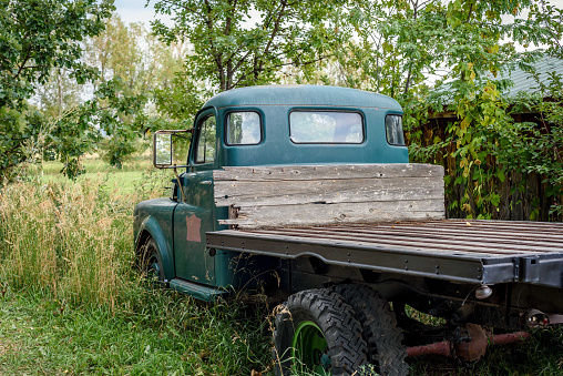 rusty old abandoned vintage pickup truck in field