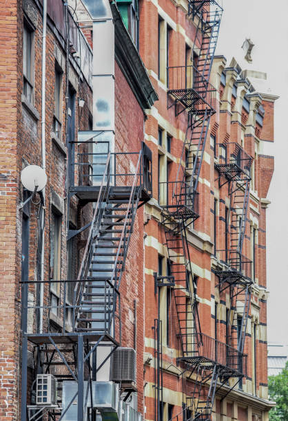 istock Fire escape ladders along brick apartment buildings 1124599200