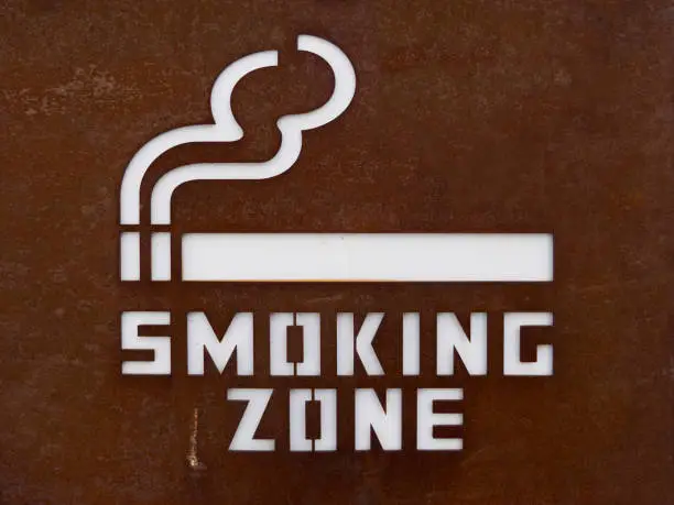 Close-up of designated smoking area sign. Sign of smoking zone. For peace of mind to separate the smokers from the non-smoking zone.