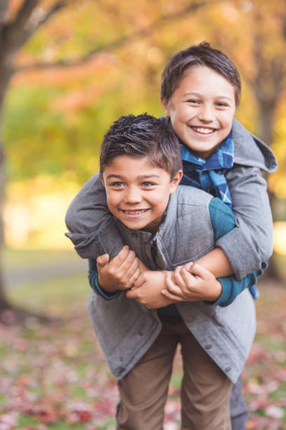 istock Two elementary-age boys walk to school through the park 1124604414