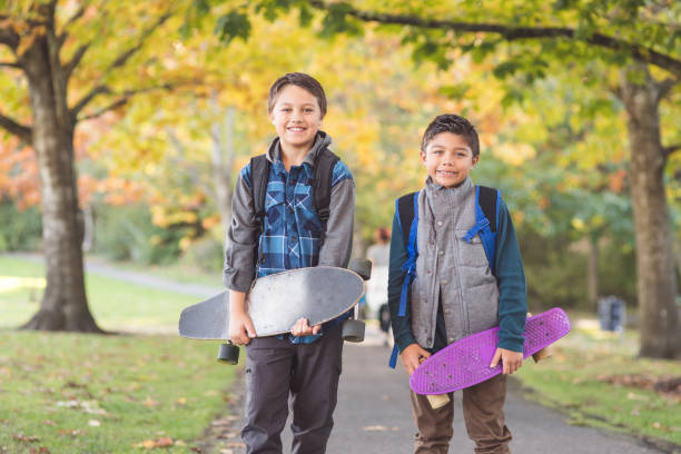 istock Two elementary-age boys walk to school through the park 1124604417
