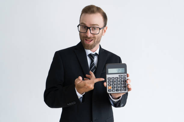 istock Enterprising bearded businessman pointing at calculator 1124605228