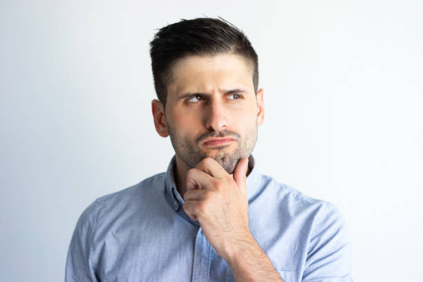 istock Pensive frowning guy in casual making decision 1124605466
