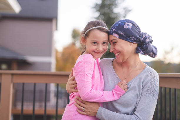 istock Mother with cancer hugging her daughter outside 1124605499
