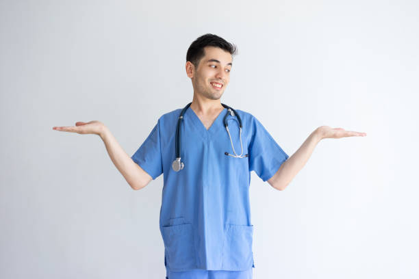 istock Smiling male doctor holding empty space with both hands 1124606239