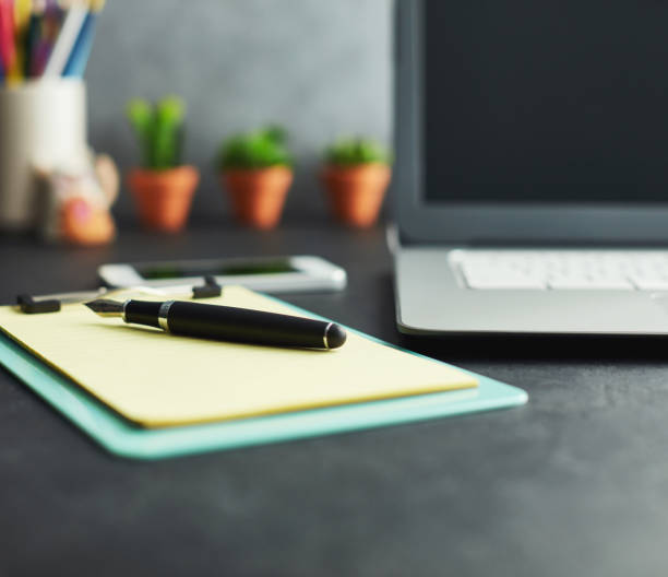 istock Work desk with clipboard, laptop and accessories 1124606282