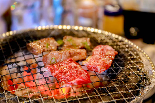 Japanese grilled meat over charcoal on stove stock photo