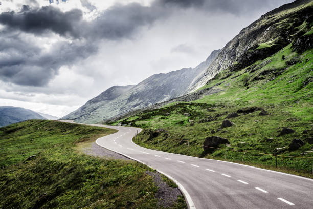 istock Winding mountain road without cars 1124611324