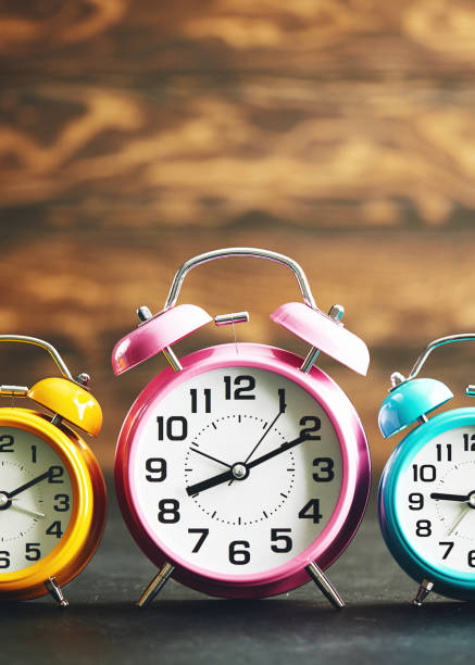 istock Vibrant colored alarm clocks in a row 1124612551