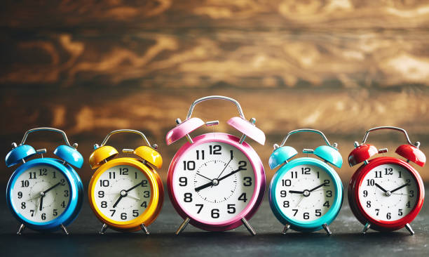 istock Vibrant colored alarm clocks in a row 1124612824