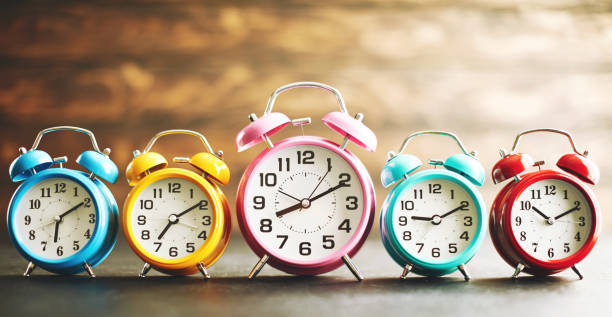 istock Vibrant colored alarm clocks in a row 1124612889