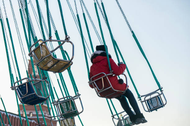 istock child having fun riding on a chain carousel in the amusement park b 1124615241