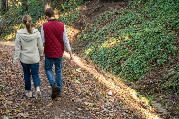 istock Young Couple Walking in the Forest Holding Hands 1124617182