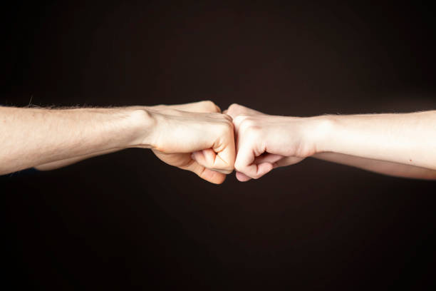 istock Fist bump or Knuckle bump between two friends f 1124618448