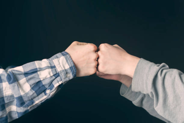 istock Fist bump or Knuckle bump between two friends f 1124618453
